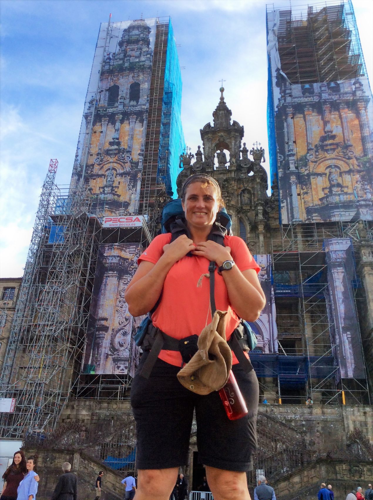 Michelle Ryan standing at the end in front of the Cathedral in Santiago, photo taken by another pilgrim