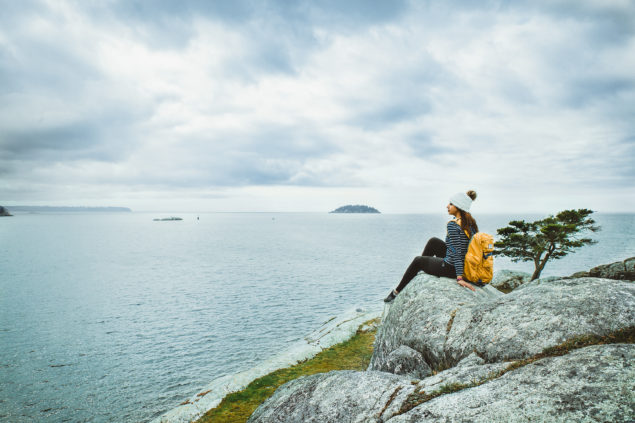 Eman Zabi looking at the horizon at Whytecliff Park in West Vancouver. Image credit Anita Lee Photography