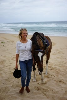 Writer Martina Abba in the beach with a horse.