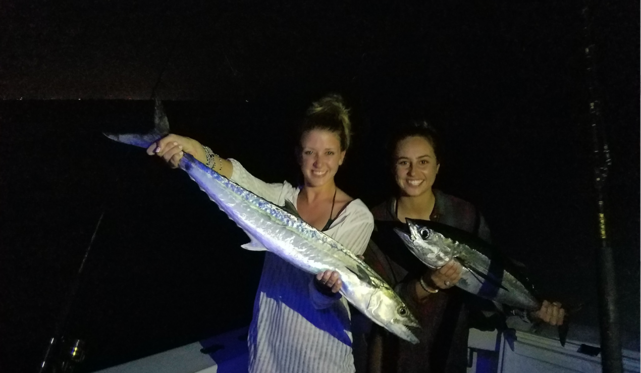 Leah H holding a King Mackerel and Alex P holding a Blackfin Tuna off West Palm Beach, FL.