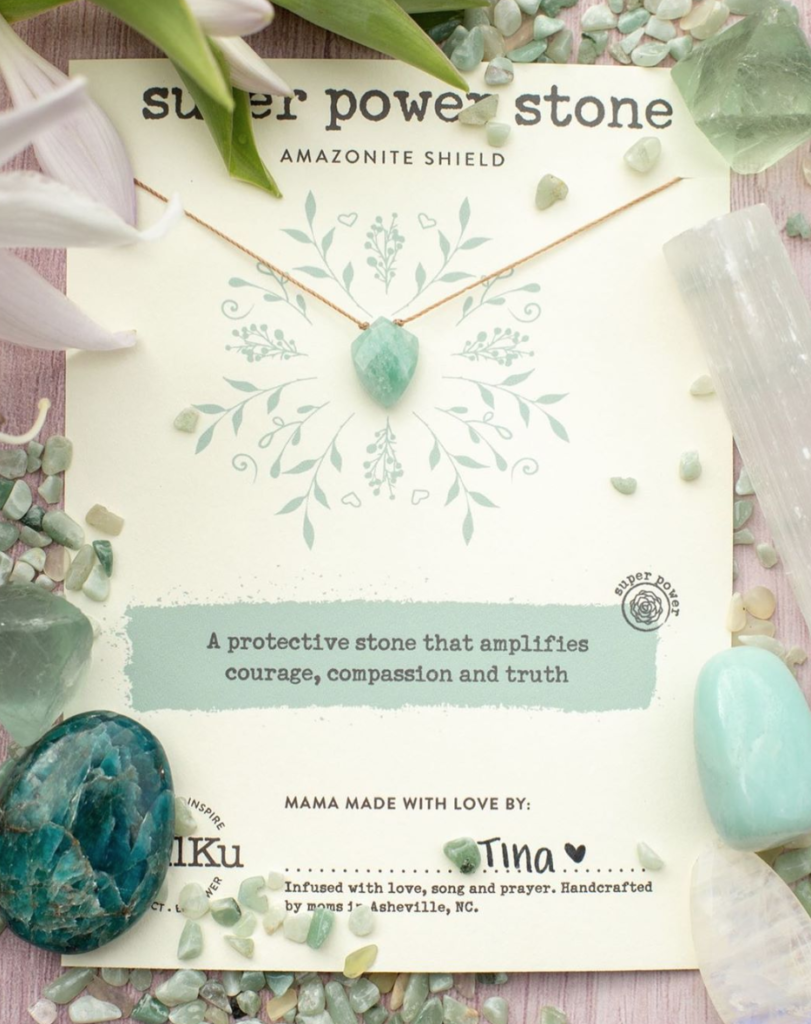 Photo of the amazonite necklace. It is green with gold colored string.